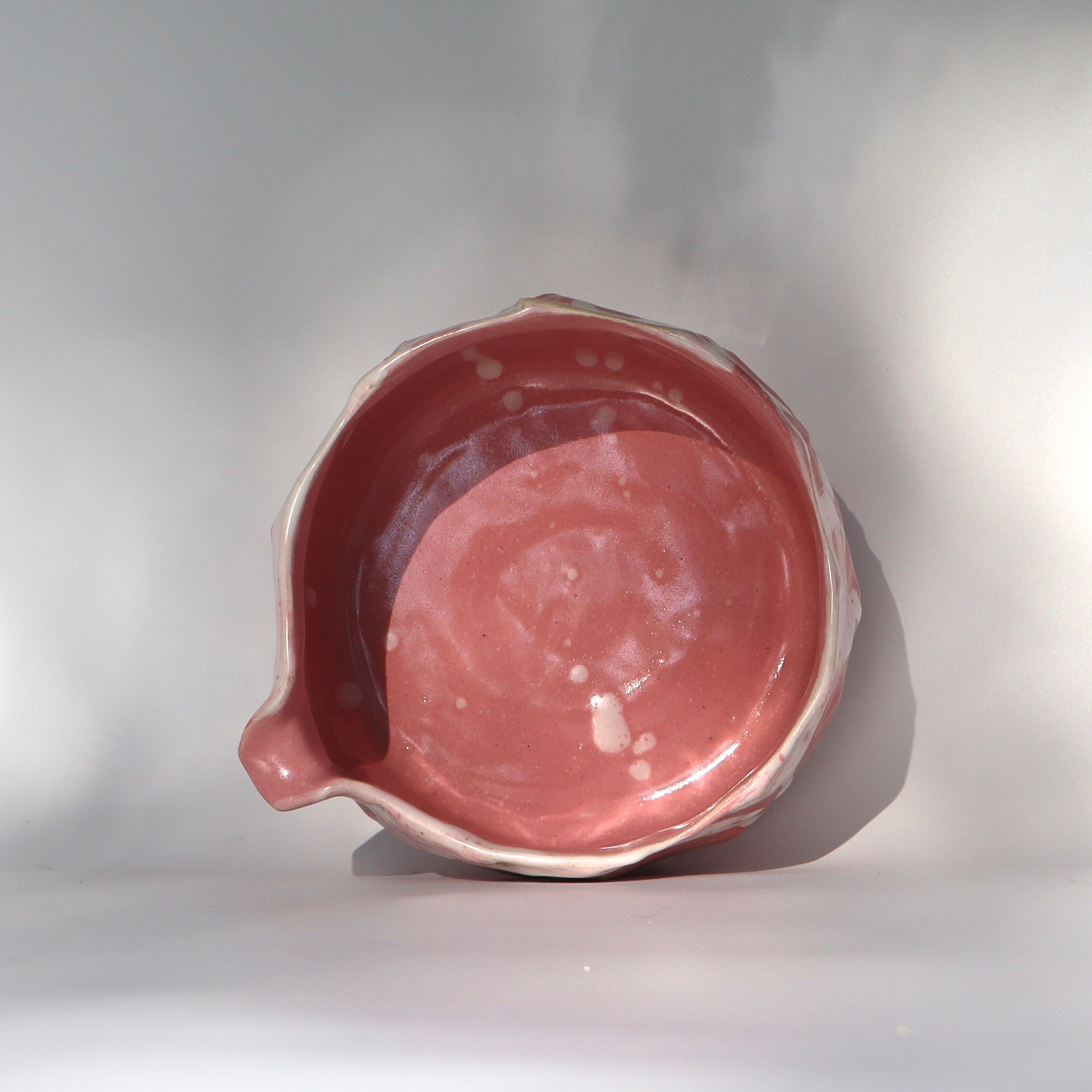 Wide base pink katakuchi matcha bowl for vigorous whisking, aerial top view