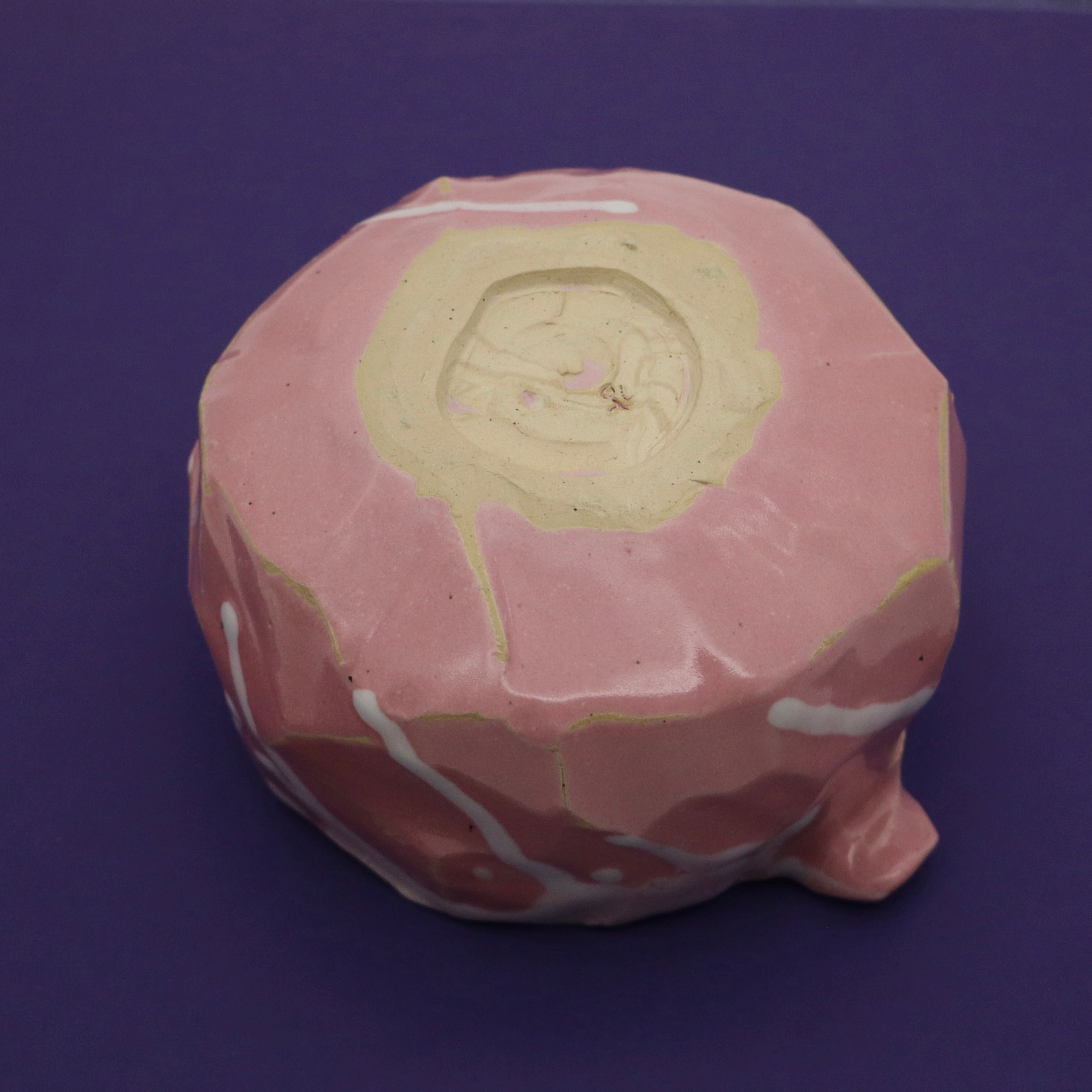 Handmade Korean kurinuki chawan signed by artist, bottom view, angled view, on purple background